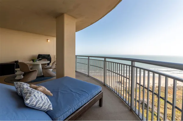 a bedroom with bed and balcony