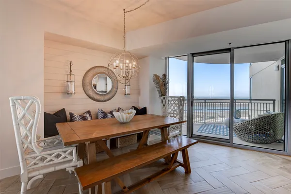 a dining room with furniture and a large window