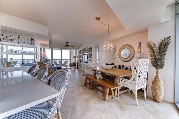 a living room with chairs and a clock on the wall