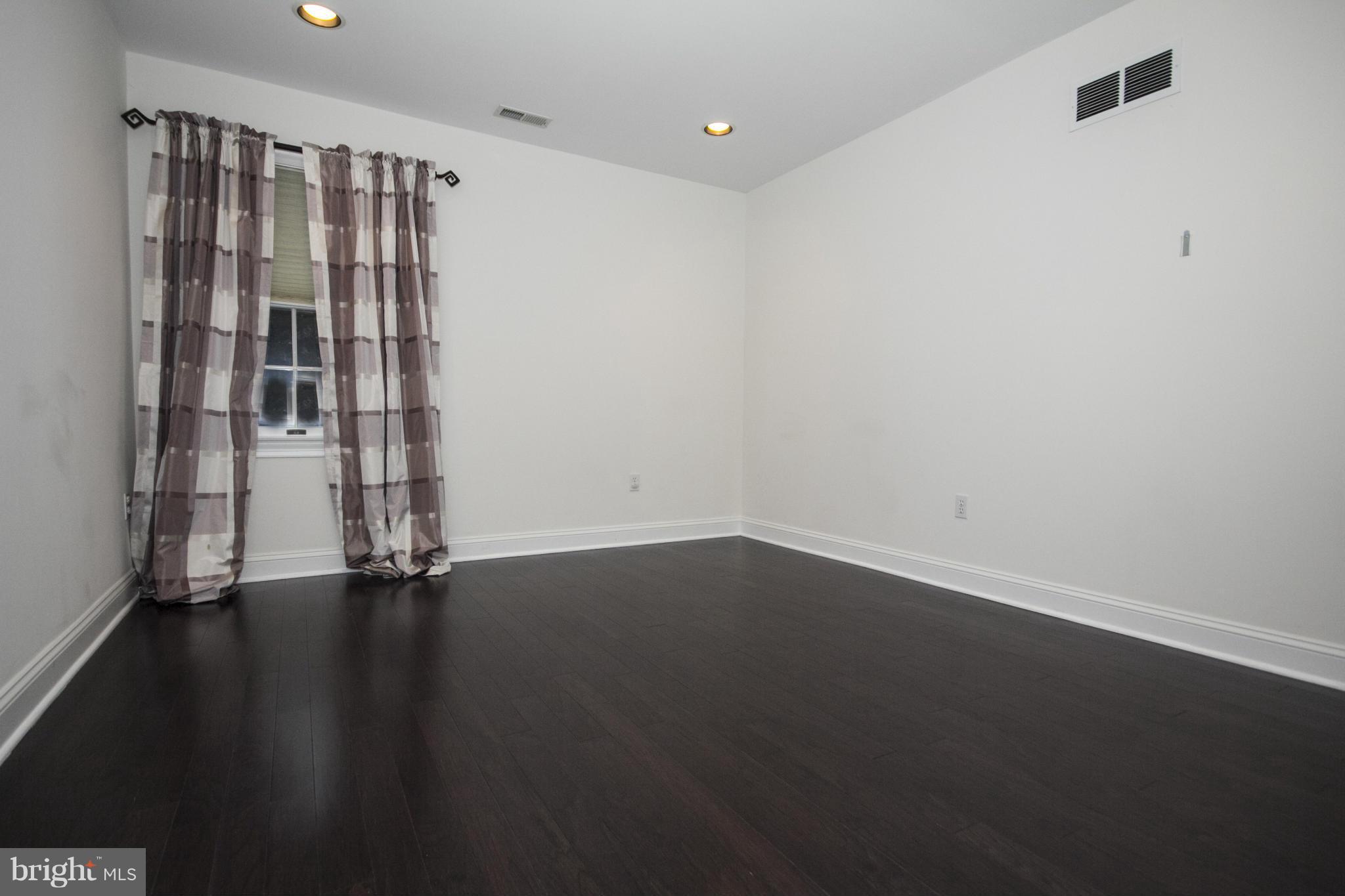 3616 Jackson Cabin Road Phoenix, MD 21131 - Photo 22 of 28 an empty room with wooden floor and windows