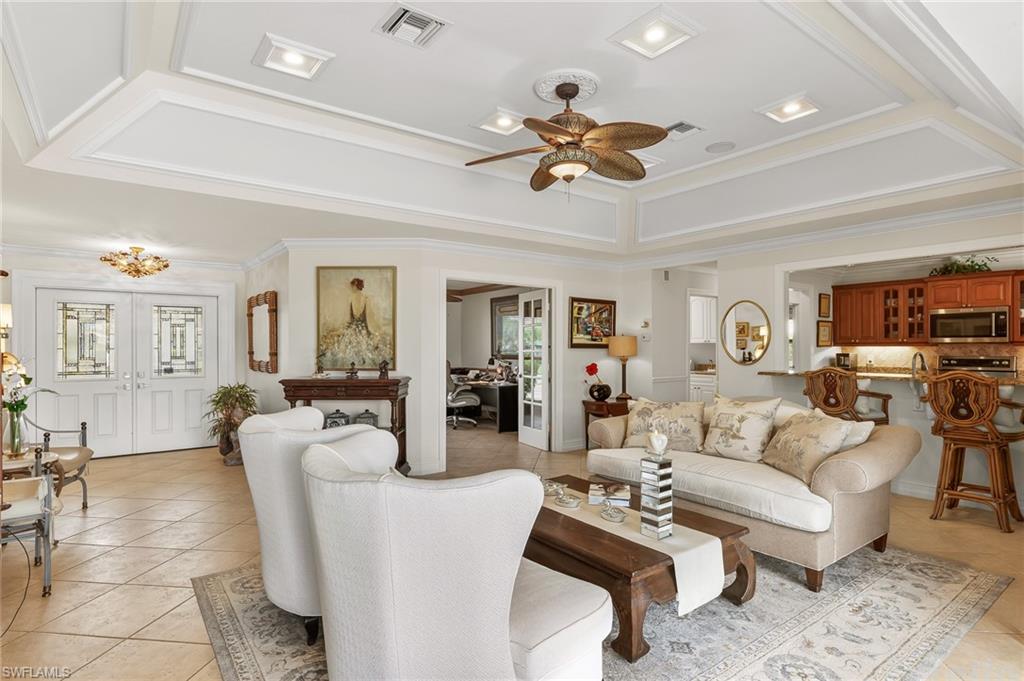 1904 Countess Court Naples, FL 34110 - Photo 6 of 33 a living room with furniture a ceiling fan and a rug