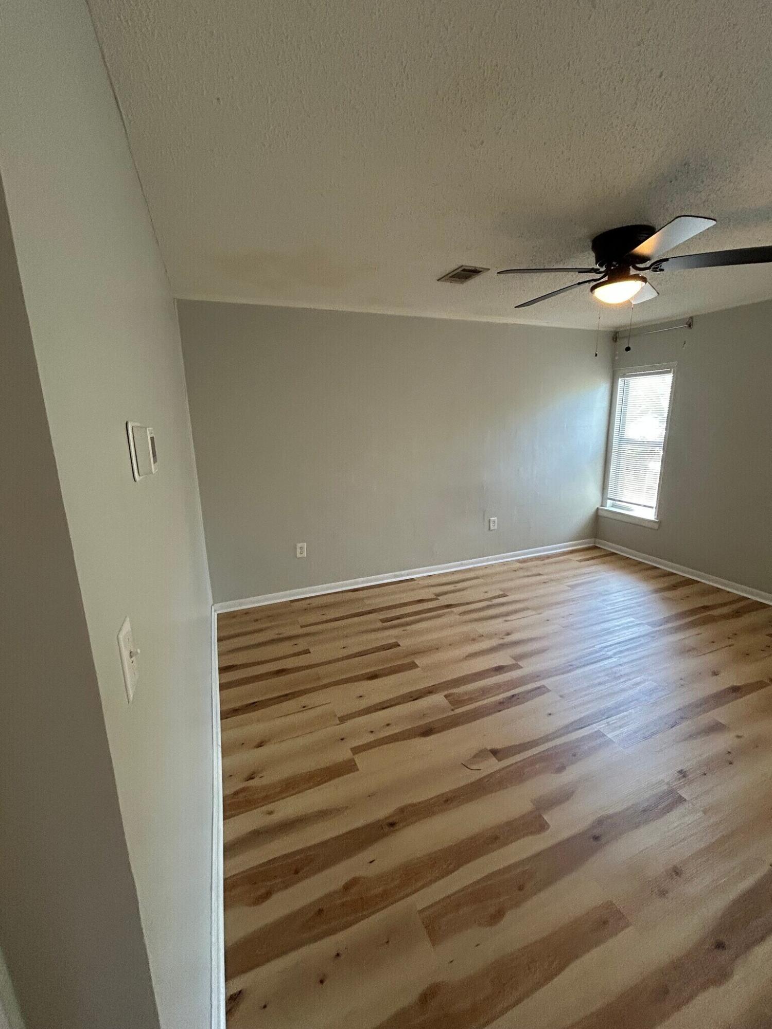 302 Santa Rosa Boulevard, Unit 11 Fort Walton Beach, FL 32548 - Photo 6 of 9 a view of a room with wooden floor