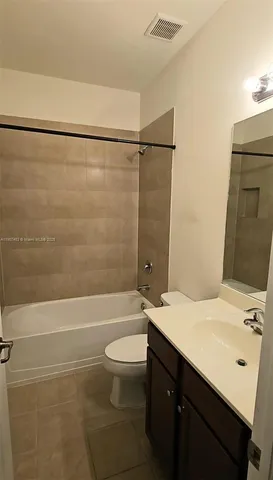 a view of a backyard with potted plants and a palm tree