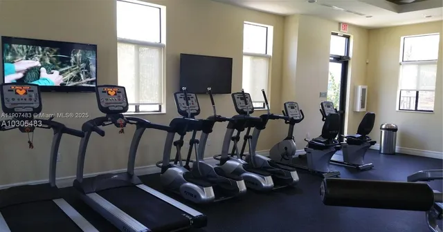 a view of a house with wooden fence next to a yard