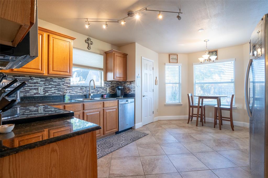 2924 Meandering Way Granbury, TX 76049 - Photo 12 of 40 a kitchen with a sink cabinets and window