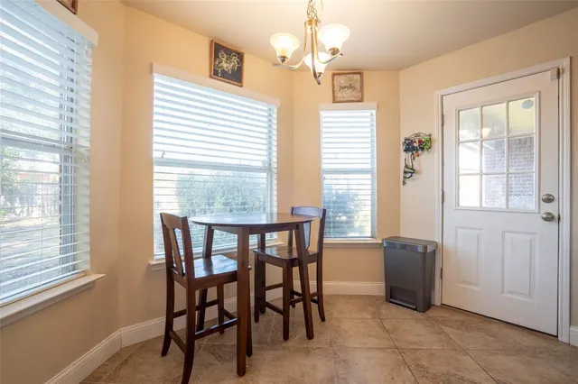 a view of a dining room with furniture and windows