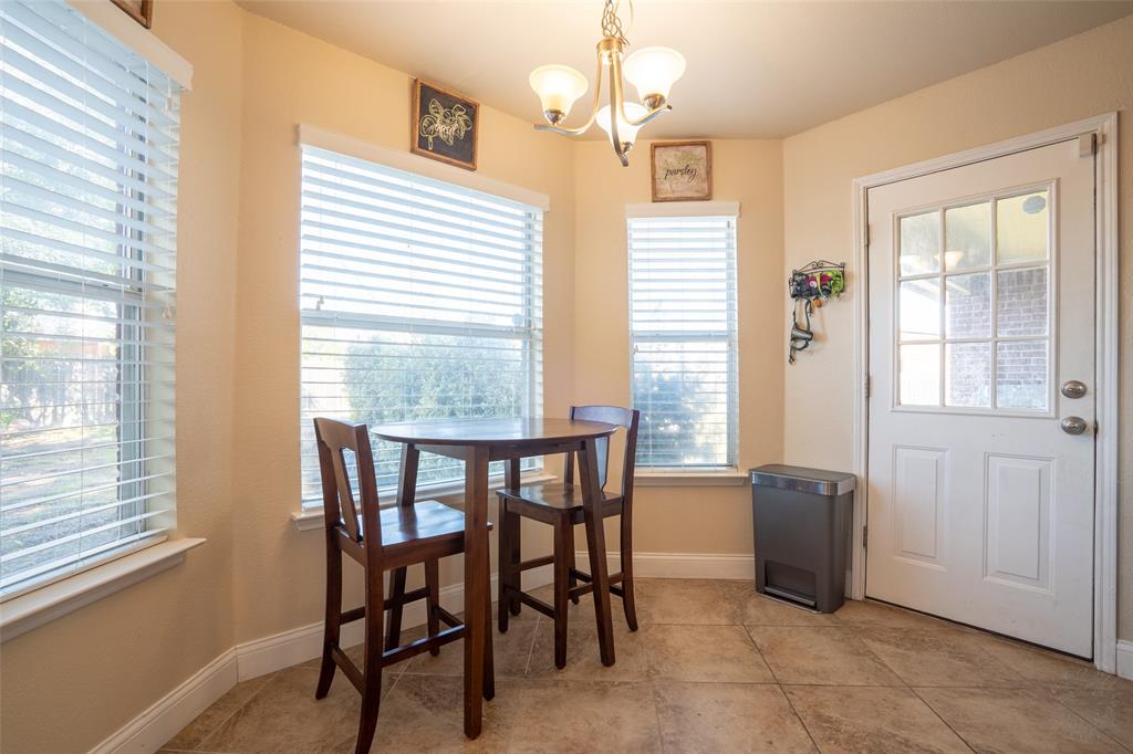 2924 Meandering Way Granbury, TX 76049 - Photo 13 of 40 a view of a dining room with furniture and windows