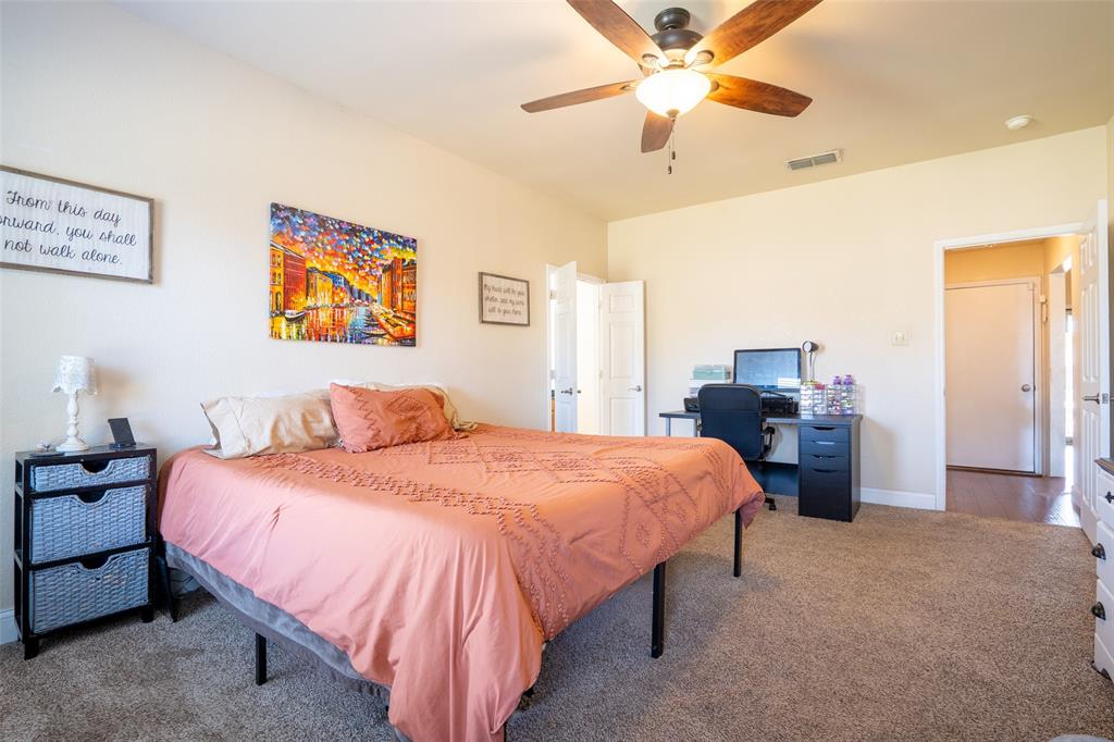 2924 Meandering Way Granbury, TX 76049 - Photo 15 of 40 a bedroom with a bed and a chandelier