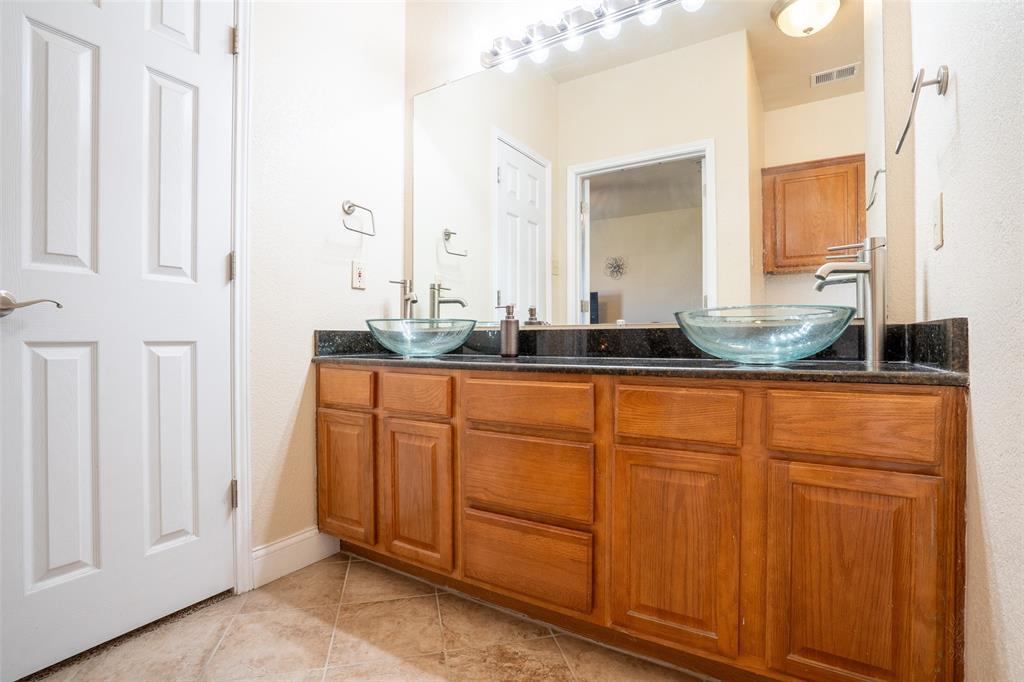 2924 Meandering Way Granbury, TX 76049 - Photo 17 of 40 a bathroom with a granite countertop sink and a mirror