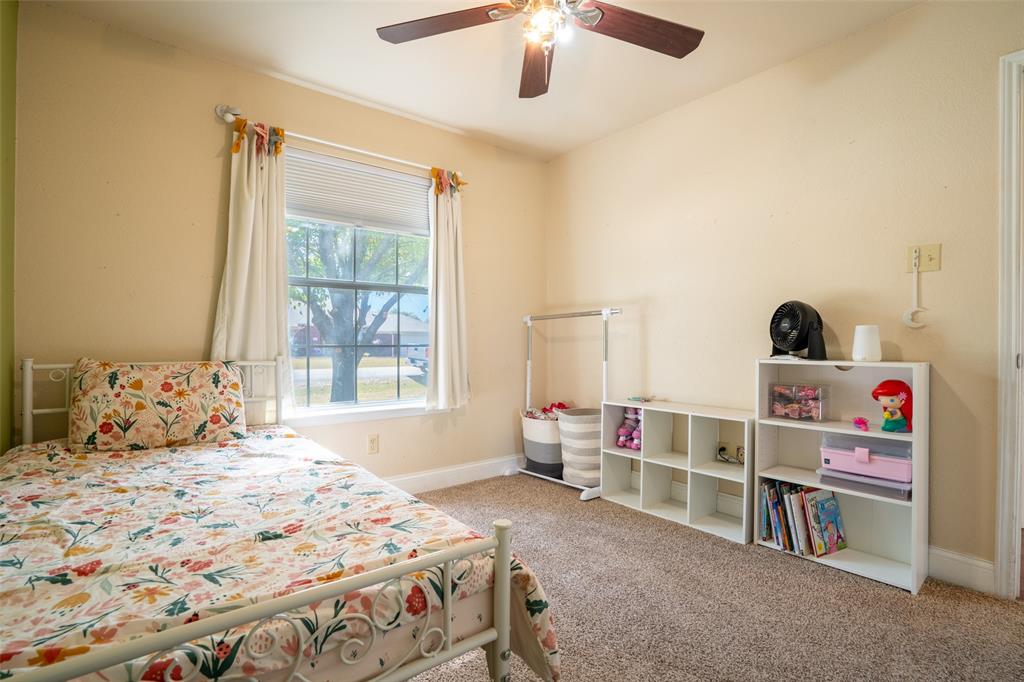 2924 Meandering Way Granbury, TX 76049 - Photo 22 of 40 a bedroom with a bed and a large window