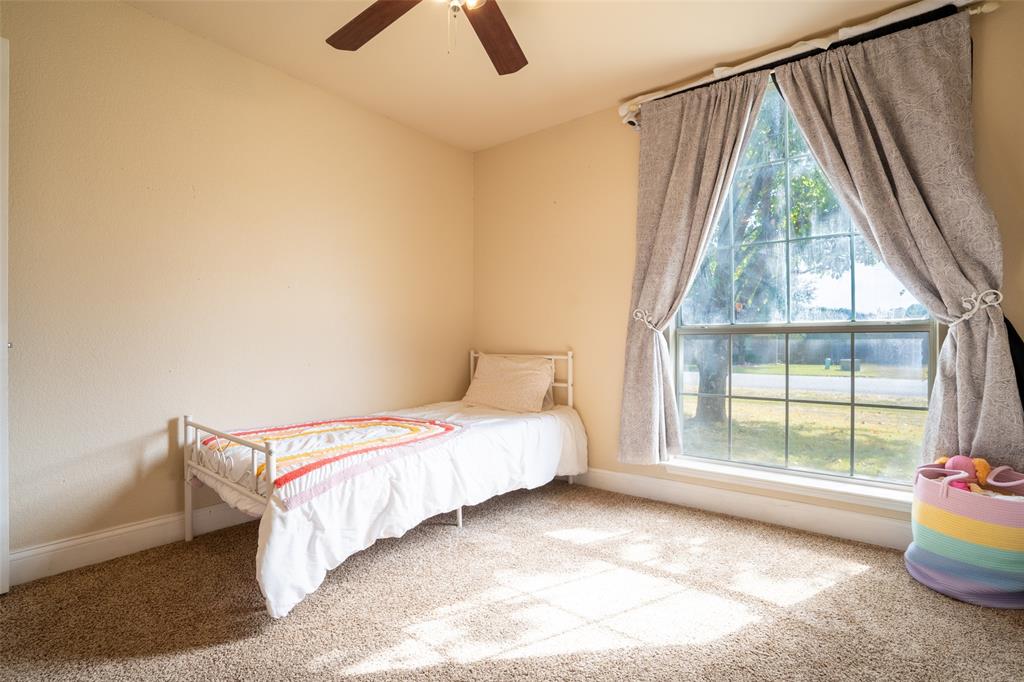 2924 Meandering Way Granbury, TX 76049 - Photo 24 of 40 a bedroom with a bed and wooden floor