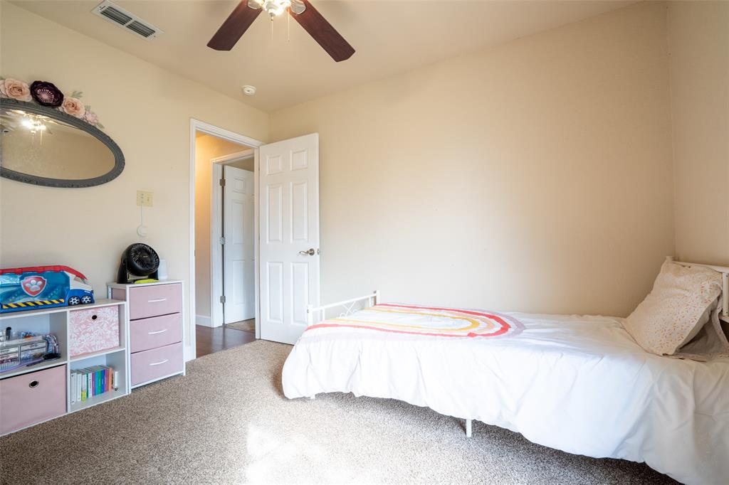 2924 Meandering Way Granbury, TX 76049 - Photo 25 of 40 a bedroom with a bed and a chandelier