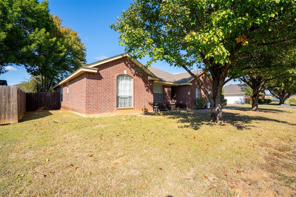 2924 Meandering Way Granbury, TX 76049 - Photo 3 of 40 a front view of a house with a yard covered in snow
