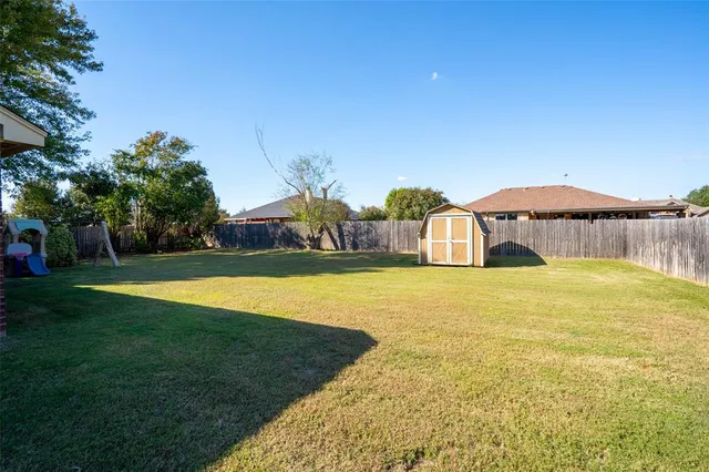 a front view of a house with a garden and swimming pool