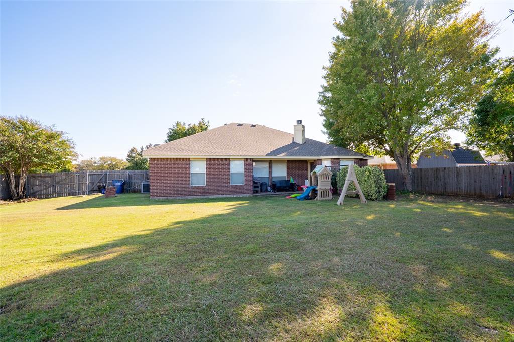 2924 Meandering Way Granbury, TX 76049 - Photo 32 of 40 a front view of a house with a garden and swimming pool