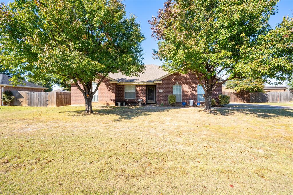 2924 Meandering Way Granbury, TX 76049 - Photo 39 of 40 a front view of a house with a yard covered with snow and trees