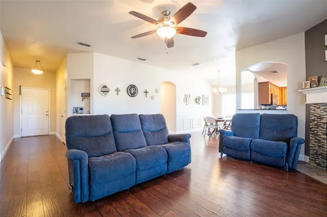 a living room with furniture and a wooden floor
