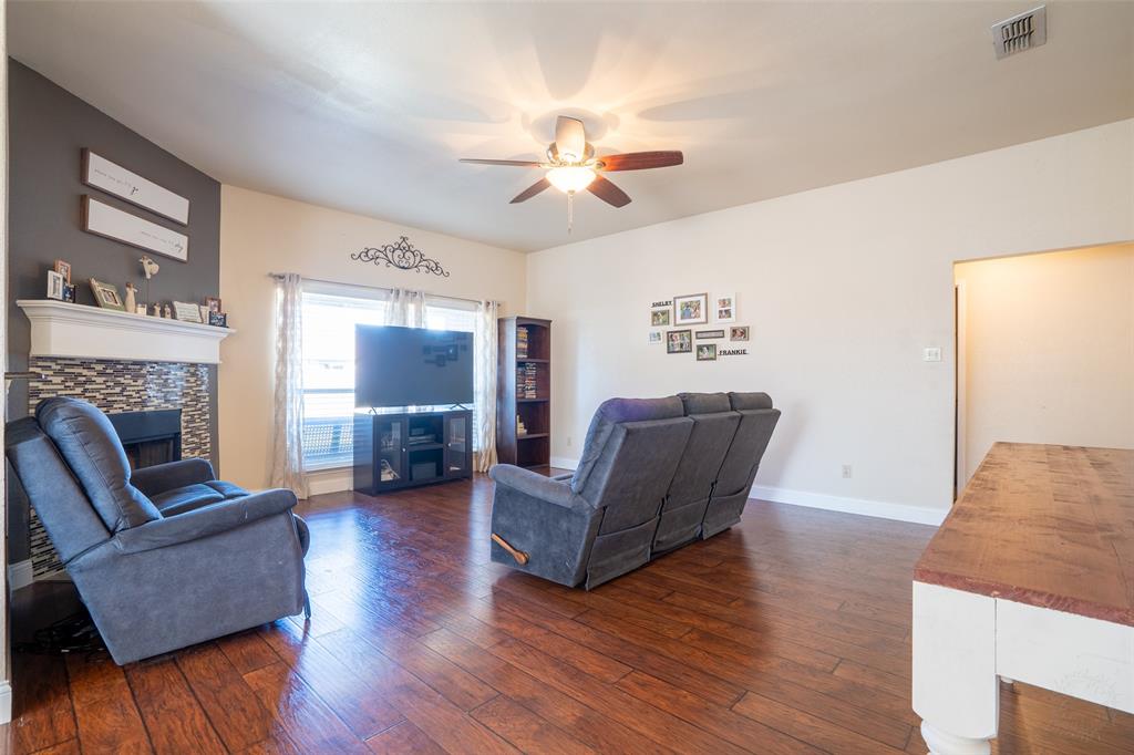 2924 Meandering Way Granbury, TX 76049 - Photo 7 of 40 a living room with furniture and a fireplace