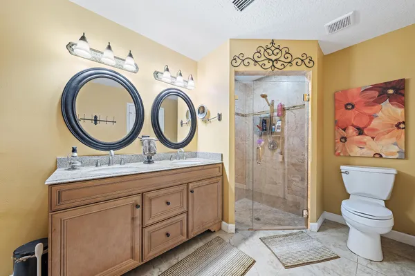 a bathroom with a toilet a sink and a mirror