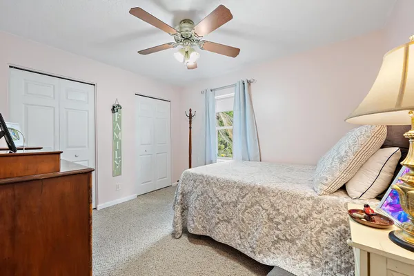 a bedroom with a bed dresser and a window