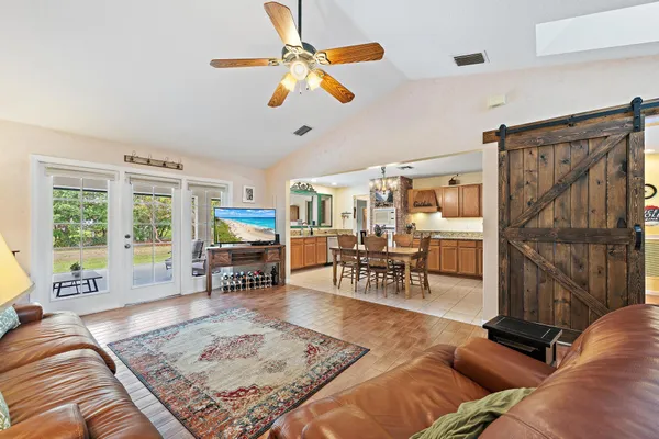 a living room with furniture and a floor to ceiling window