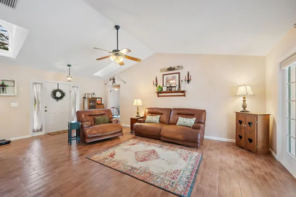 a living room with furniture a couch and a chandelier