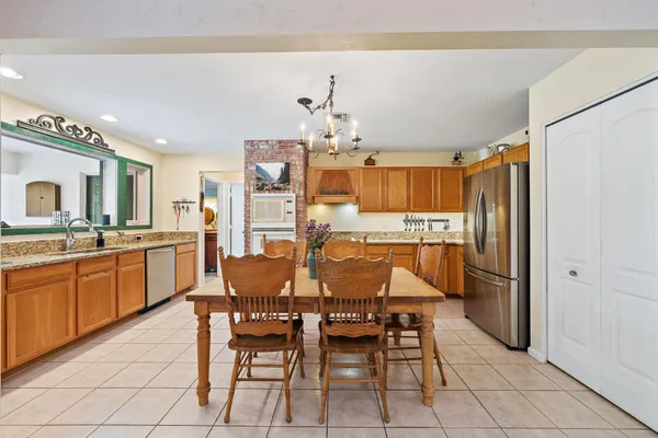 a large kitchen with a table and chairs