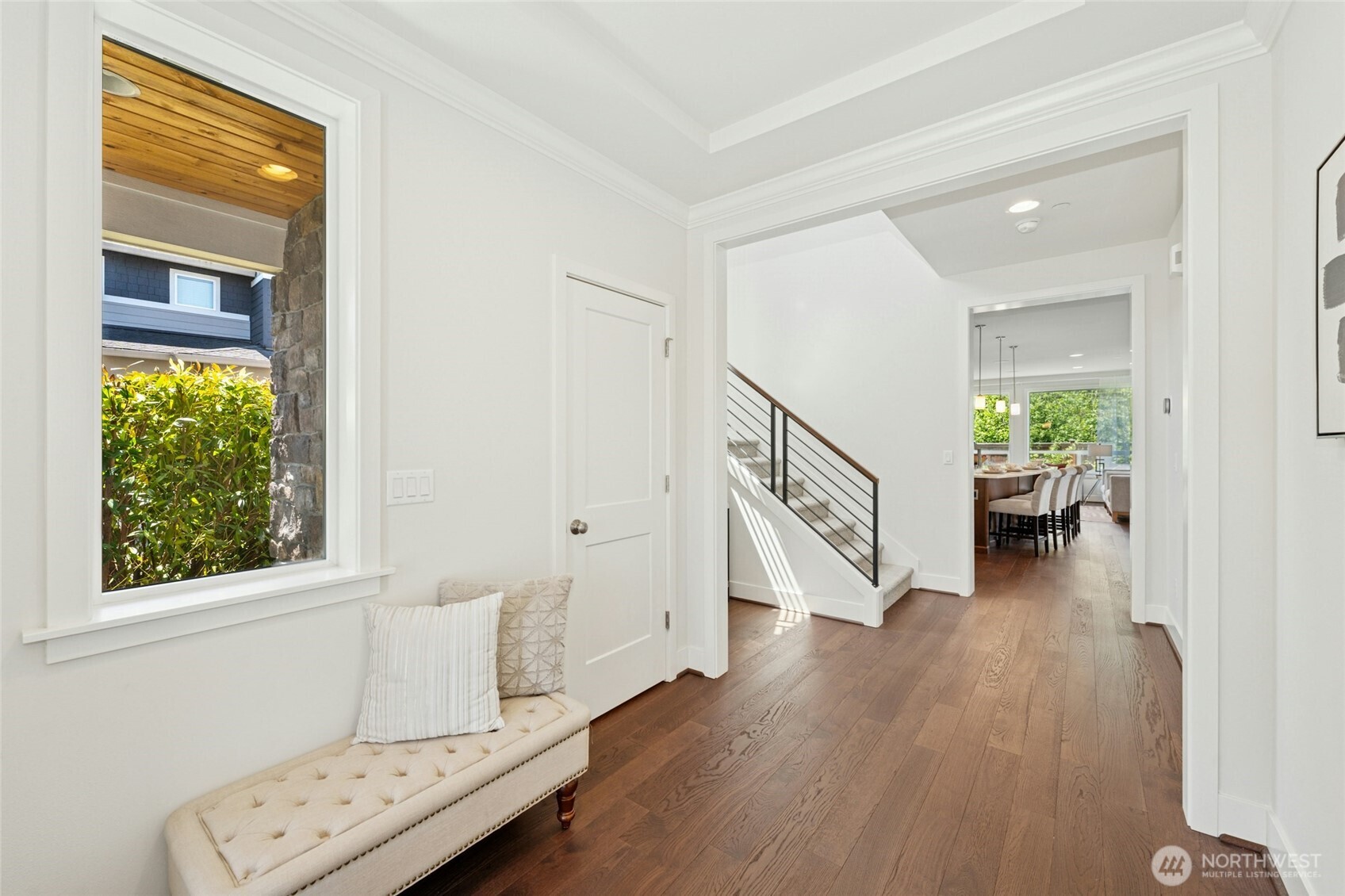 4309 231st Place Southeast Bothell, WA 98021 - Photo 4 of 40 a view of an entryway with wooden floor leading to a furnished livingroom and windows