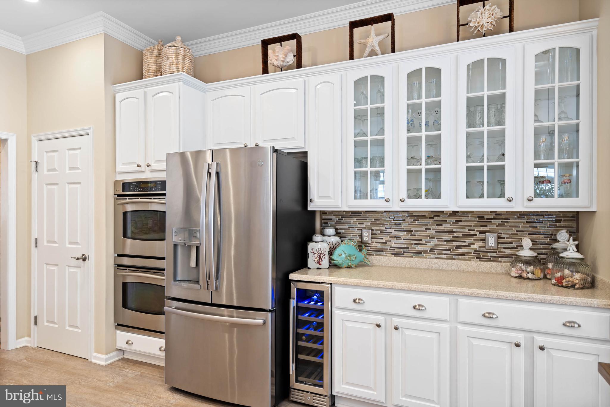 32876 Ocean Reach Lewes, DE 19958 - Photo 17 of 68 a kitchen with stainless steel appliances white cabinets and a refrigerator