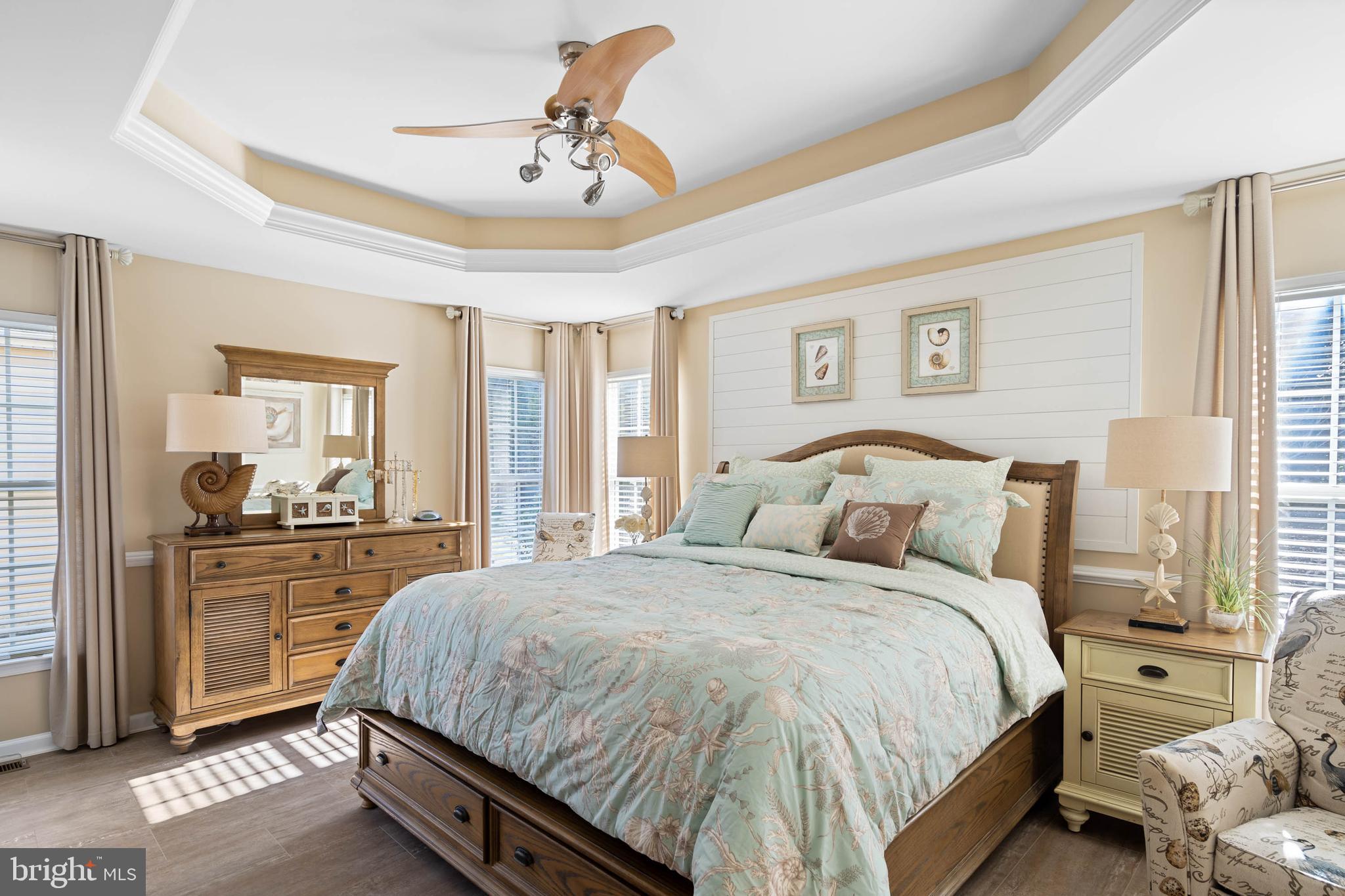 32876 Ocean Reach Lewes, DE 19958 - Photo 29 of 68 a bedroom with a large bed and a chandelier