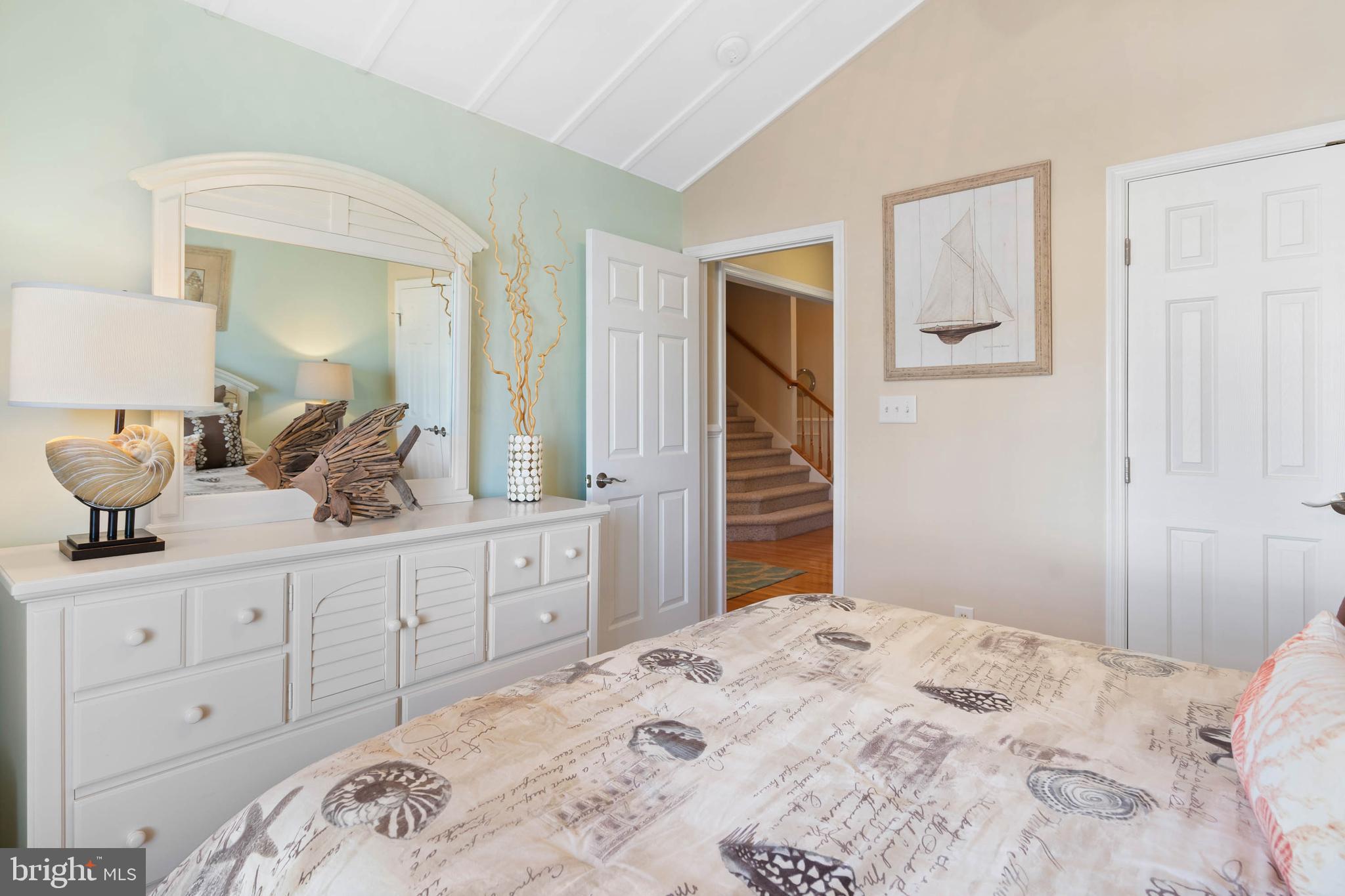 32876 Ocean Reach Lewes, DE 19958 - Photo 36 of 68 a bedroom with a bed and a dresser