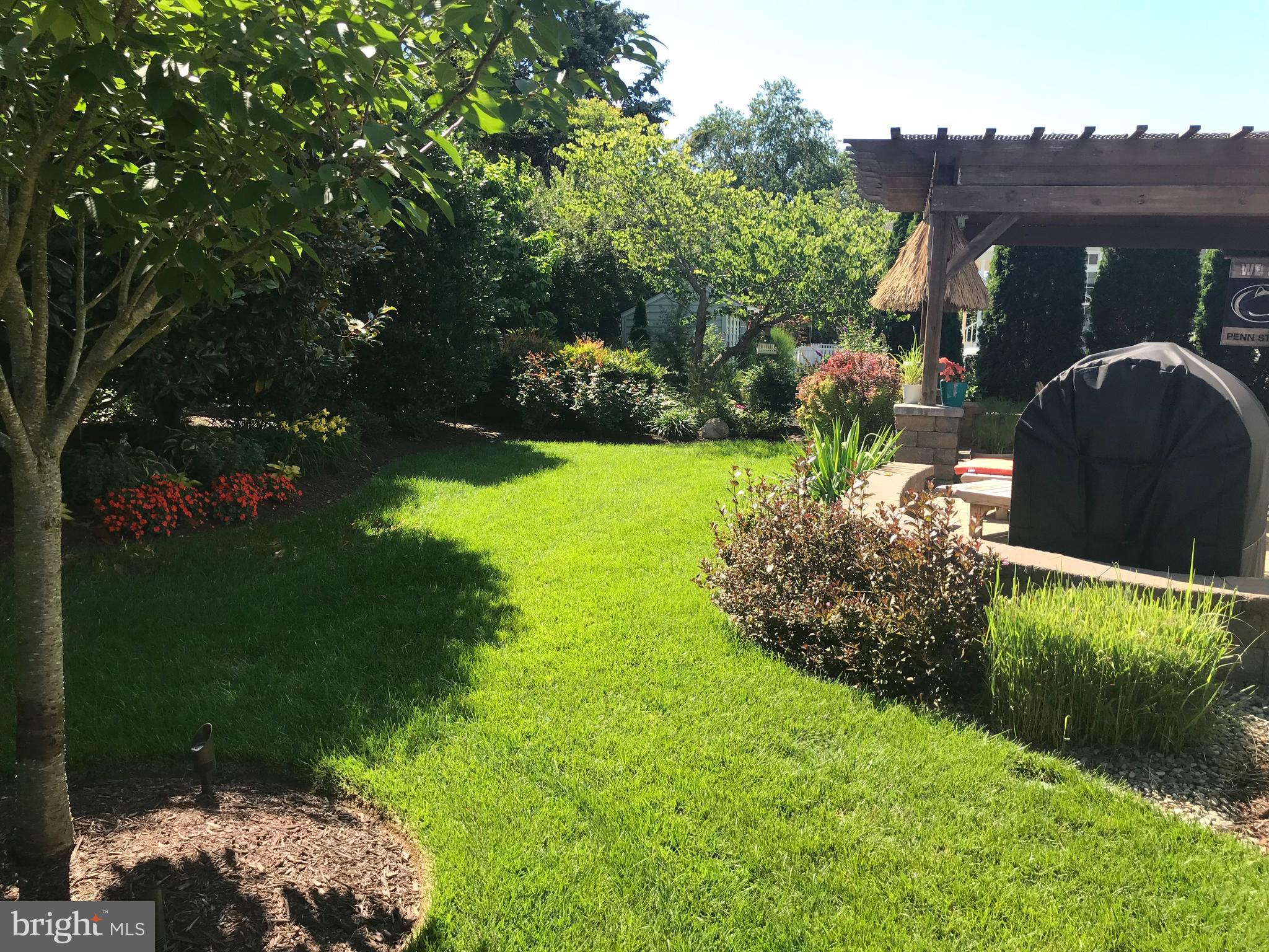 32876 Ocean Reach Lewes, DE 19958 - Photo 61 of 68 a backyard of a house with lots of green space and outdoor seating