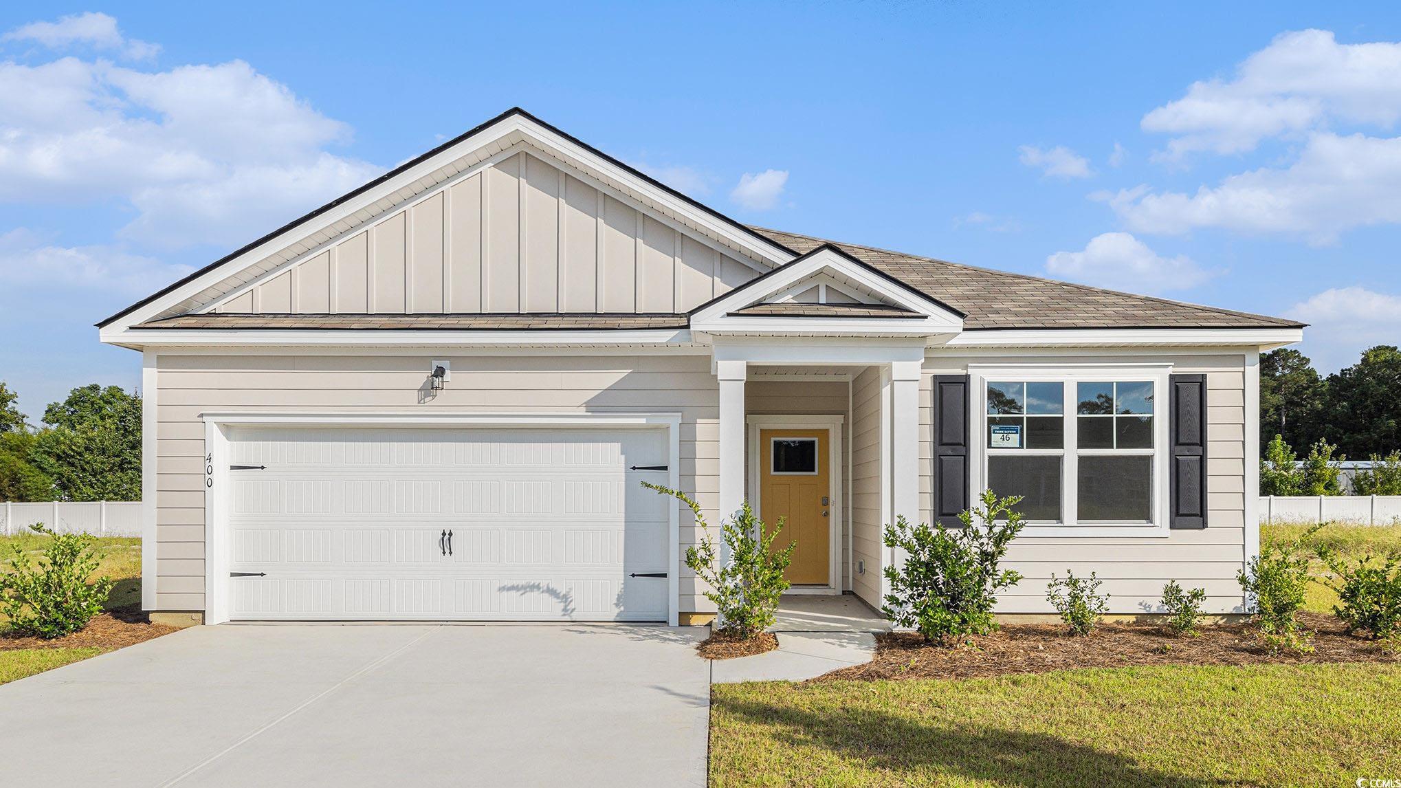 View of front of house featuring board and batten siding, concrete driveway, an attached garage, and a shingled roof