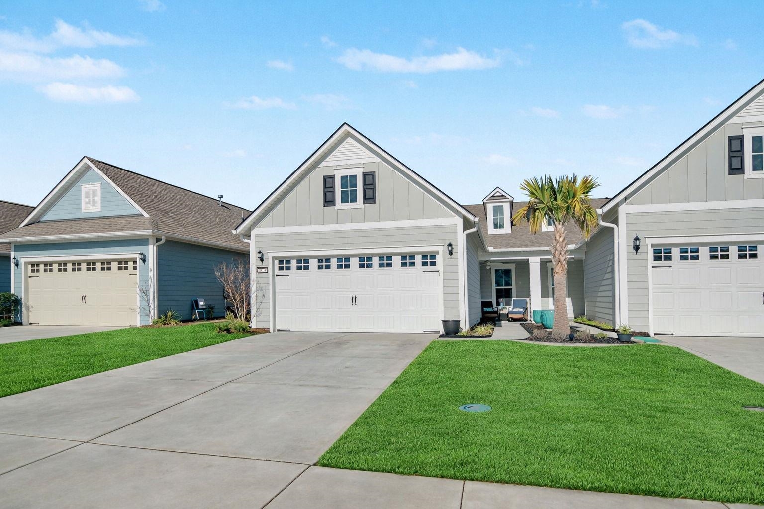5830 Cremona Drive Myrtle Beach, SC 29577 - Photo 1 of 39 Craftsman-style home featuring board and batten siding, a garage, and a front yard
