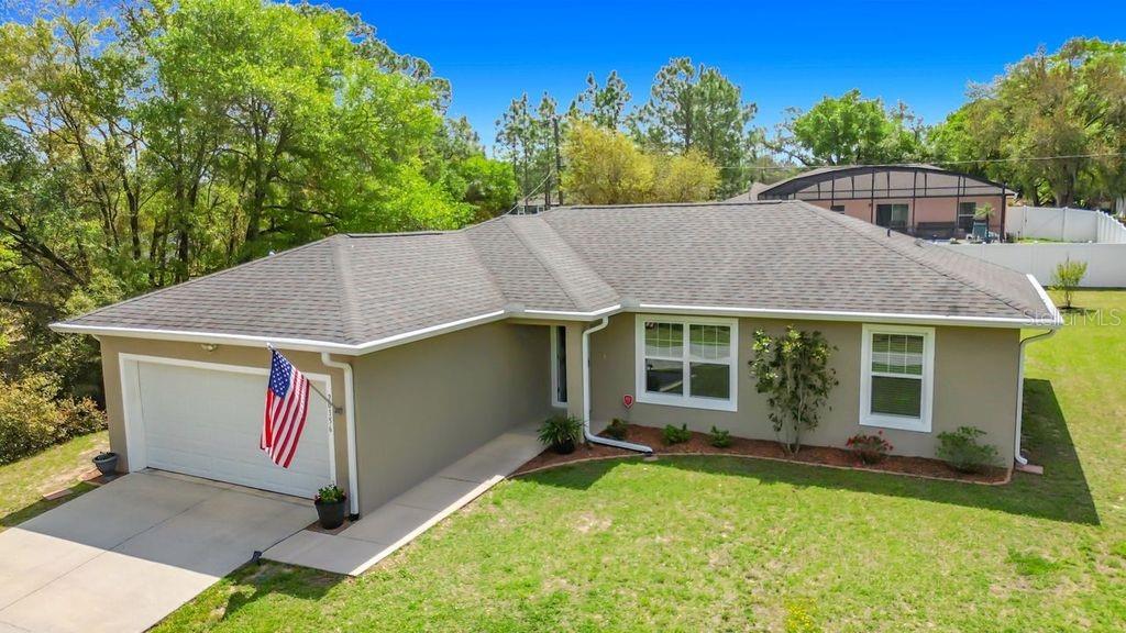 20156 Southwest 83rd Place Dunnellon, FL 34431 - Photo 1 of 28 an aerial view of house with yard and trees in the background