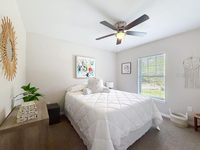 20156 Southwest 83rd Place Dunnellon, FL 34431 - Photo 13 of 28 a bedroom with a bed and a window