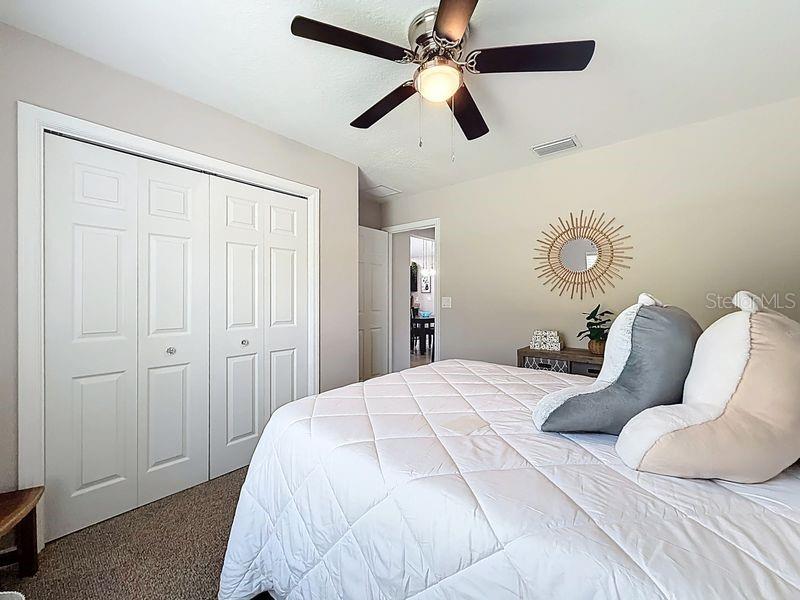 20156 Southwest 83rd Place Dunnellon, FL 34431 - Photo 14 of 28 a bedroom with a bed and ceiling fan