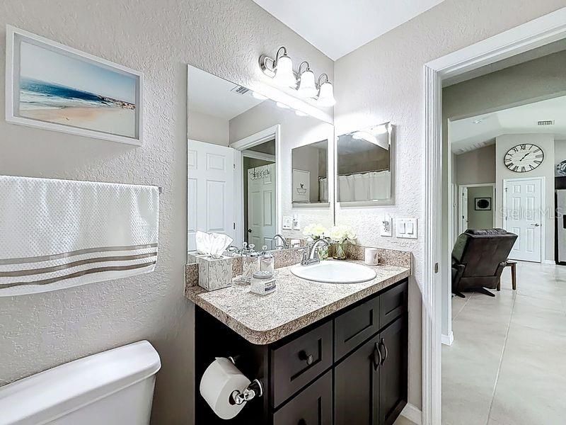 20156 Southwest 83rd Place Dunnellon, FL 34431 - Photo 16 of 28 a bathroom with a granite countertop sink a toilet and a mirror