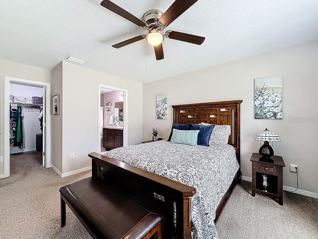 20156 Southwest 83rd Place Dunnellon, FL 34431 - Photo 17 of 28 a bed room with a bed and a chandelier