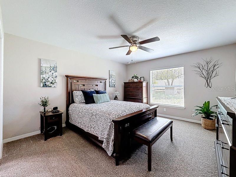 20156 Southwest 83rd Place Dunnellon, FL 34431 - Photo 18 of 28 a bedroom with a bed and a chandelier