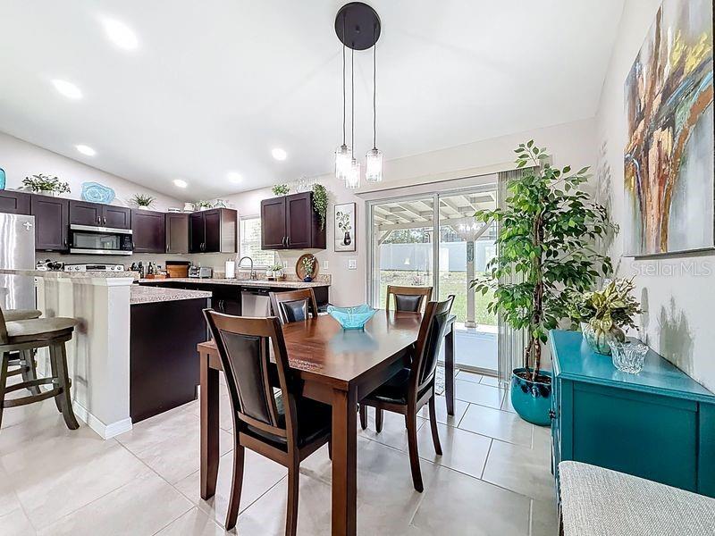 20156 Southwest 83rd Place Dunnellon, FL 34431 - Photo 6 of 28 a kitchen with stainless steel appliances granite countertop a dining table chairs and a refrigerator