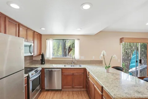 a kitchen with granite countertop a sink and a large window