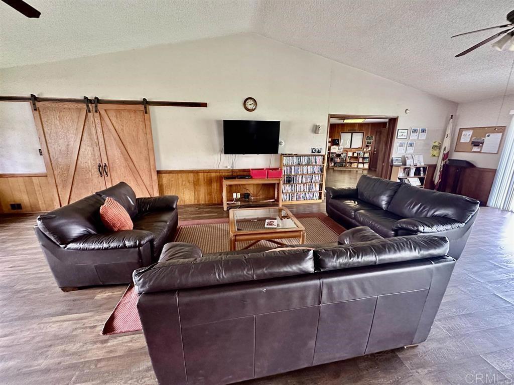 4812 Old Cliffs Road San Diego, CA 92120 - Photo 11 of 11 a living room with furniture and a flat screen tv