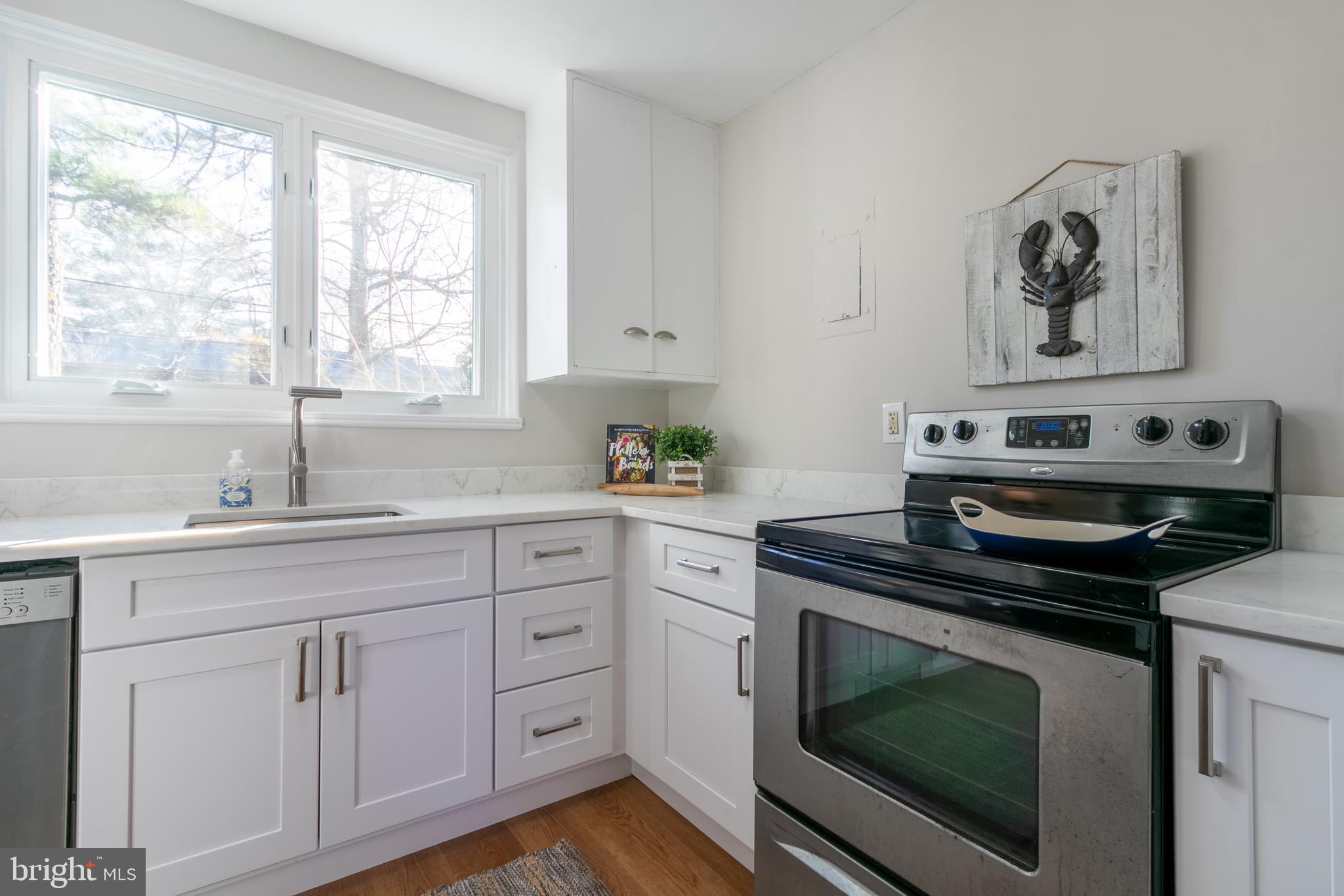 45 Ridge Road Greenbelt, MD 20770 - Photo 15 of 33 a kitchen with cabinets appliances and a window