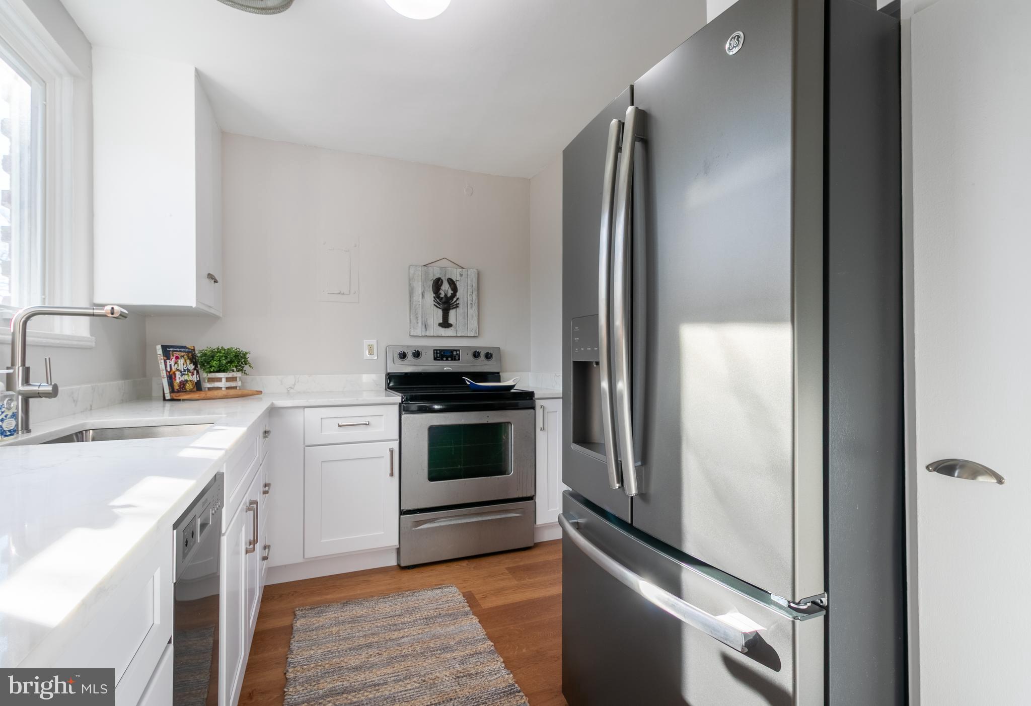 45 Ridge Road Greenbelt, MD 20770 - Photo 17 of 33 a kitchen with stainless steel appliances granite countertop a refrigerator and a sink