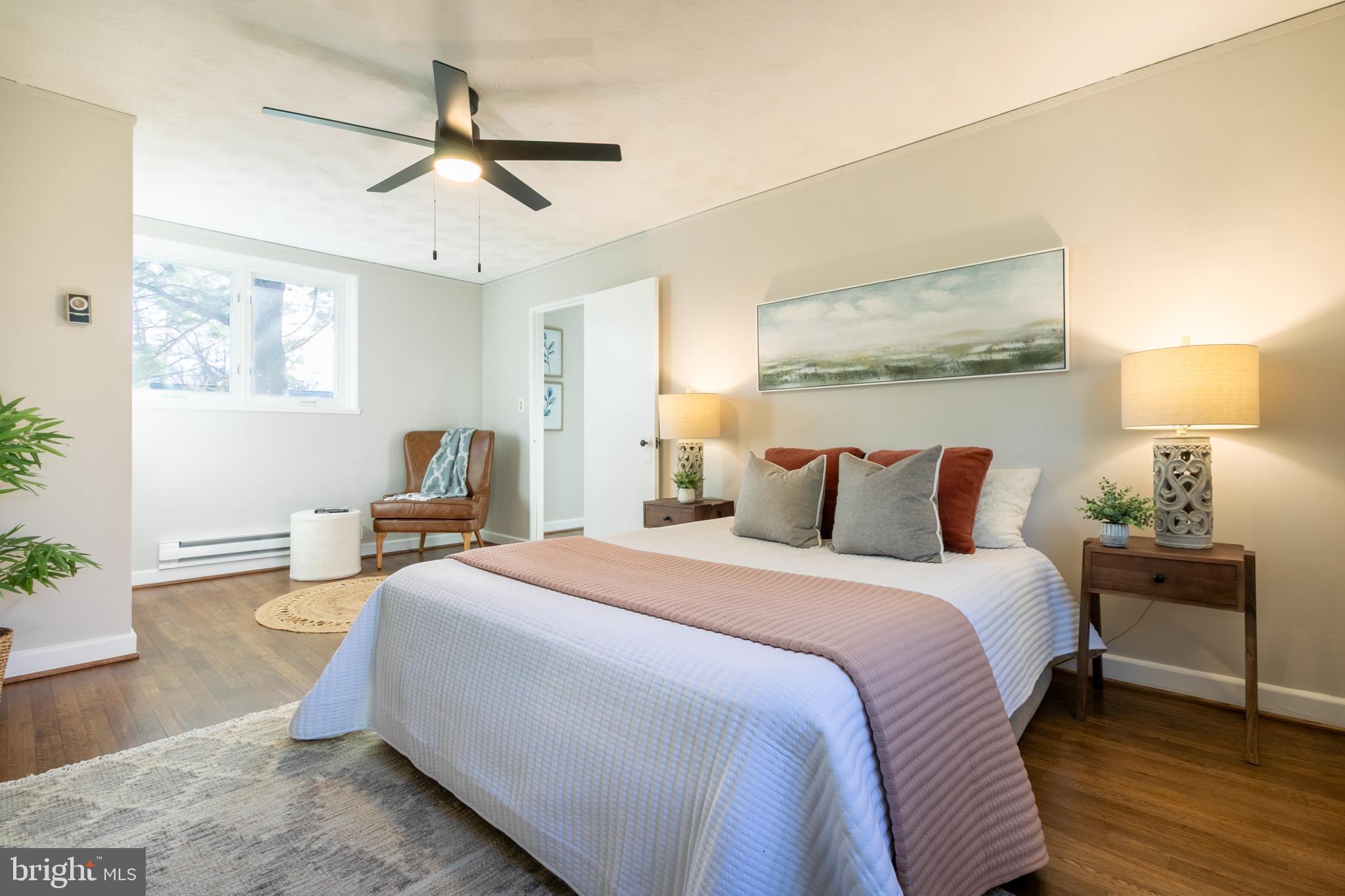 45 Ridge Road Greenbelt, MD 20770 - Photo 18 of 33 a spacious bedroom with a bed and wooden floor