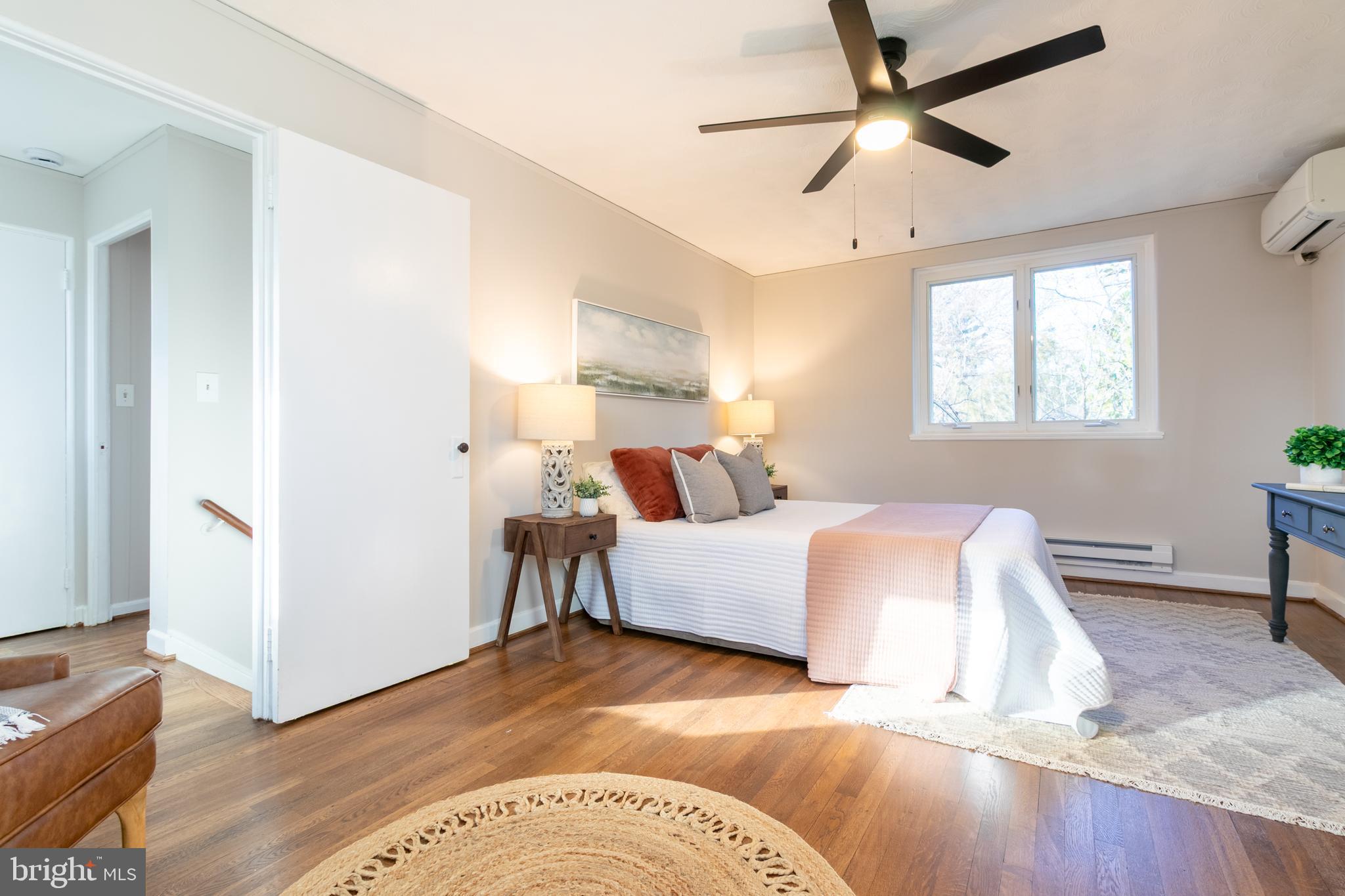45 Ridge Road Greenbelt, MD 20770 - Photo 20 of 33 a spacious bedroom with a bed and a wooden floor