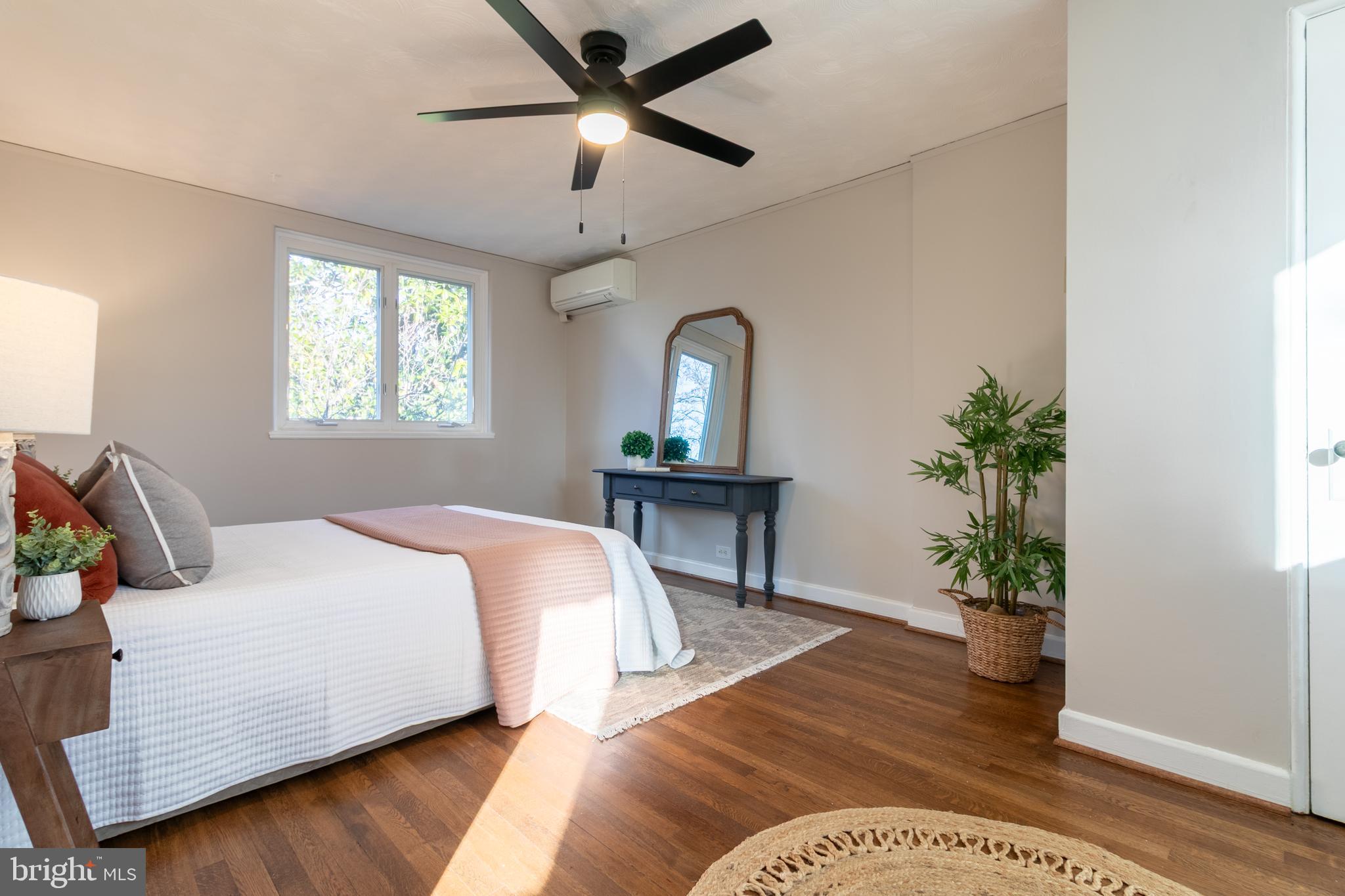 45 Ridge Road Greenbelt, MD 20770 - Photo 21 of 33 a bedroom with a bed and a potted plant