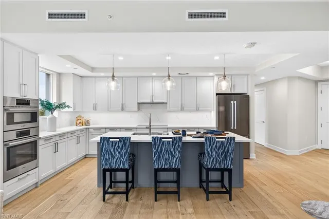 a bathroom with a granite countertop sink a toilet a mirror and shower