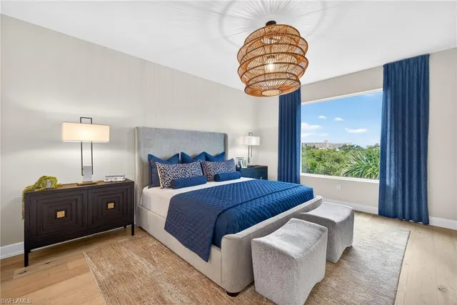 a view of a dining room with furniture large windows and wooden floor